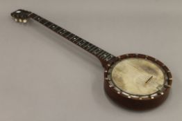 A Douglas and Co banjo with inlaid back.