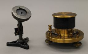 A lacquered brass scientific stand with built in spirit levels and another scientific stand.