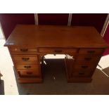Late Victorian ash twin pedestal desk with central drawer flanked by four drawers to each pedestal