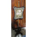 William IV rosewood pole screen with shaped wool work banner on brass column, the shaped base on