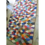 Modern wool rug, all over decorated with a multi coloured lozenge design (300cm x 150cm)