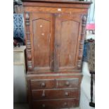 Victorian pine cupboard on chest with stepped cornice above a pair of doors enclosing fitted