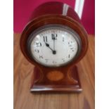 Edwardian inlaid mahogany balloon shaped mantel time piece with white Arabic dial on four brass ball