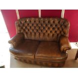 Brown leather wing-back Chesterfield style suite, comprising of button back two seat sofa and