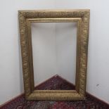 Large early 20th C gilt wood and gesso rectangular picture frame, aperture 62.5cm x 101cm