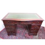 Modern mahogany reproduction desk with green inset top and central drawer W122cm D61cm H77cm