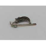 Gold bar brooch set with a single turquoise stamped 9ct, and a white metal brooch in the form of a