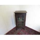 Early 20th C Art Nouveau style oak cabinet enclosed by single lead glazed door with coloured glass