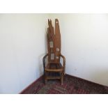 Rustic wooden made throne type chair with pierced high back and down scrolled arms, with solid