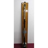 Negretti & Zambra of London stick barometer on golden oak wall plaque