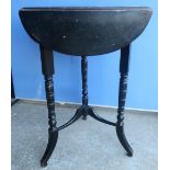 Late Victorian ebonised triangular form drop-leaf occasional table on turned supports (H67cm)