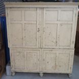Large Victorian pine housekeepers cupboard with moulded cornice enclosed by four four panelled doors