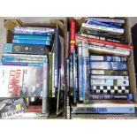 Two boxes containing a large quantity of military aircraft books, including The Men Who Flew The