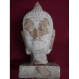 Pottery model of a Tibetan deity head, with remnants of white finish, on a rectangular base, H43cm