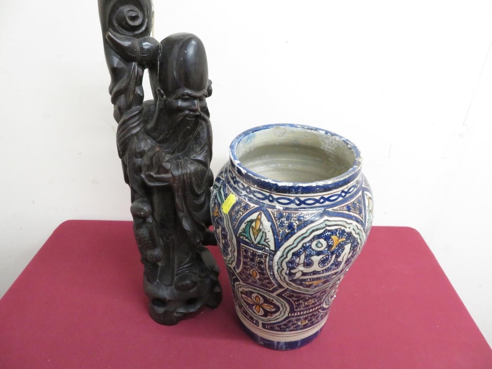 Islamic vase painted blue decoration, H31cm, and a carved eastern hardwood table lamp in the form of