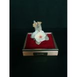 Lladro decorative flower on a red velvet base with glass box top.