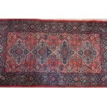 Chinese salmon pink ground rectangular rug, relief decorated with flowers and seal marks 154cm x