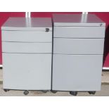 Modern office desk with chrome legs, two small filing cabinets with three drawers and two office