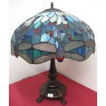 Verdigris metal table lamp, with acanthus cast column on four paw feet with Tiffany dragonfly