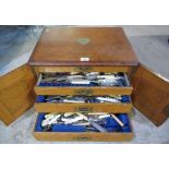 Edwardian oak four drawer canteen with brass cartouche stamped W containing a quantity of EPNS