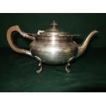 Early 20th C silver plated tea pot of squat baluster form, ebony scroll handled and finial on four