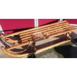 Child's Davos wooden sledge with metal runners and rope pulley