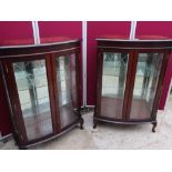 Pair of mahogany bowfront display cabinets, each with two plate glass shelves on short cabriole legs