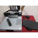 Bose SoundDock music system with instructions in box and a Loewe XEMIX DVD player with remote,