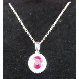 18ct white gold ruby and diamond oval pendant, approx 75 points, on chain, boxed