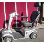 Silver Rascal mobility scooter with arm and head rests, key and charger