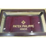 Mahogany table-top glazed display cabinet with hinged lid with later applied Patek Philippe