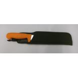 Modern machete type knife with composite grip and frog sheath