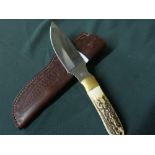 Sheffield made sheath knife with four inch swollen blade, brass mounts and two piece Sambar horn
