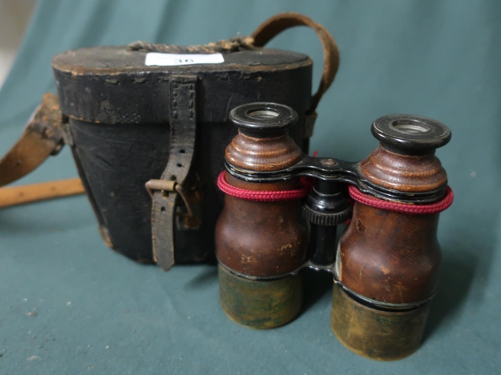 A pair of leather bound field glass in case