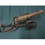 Brass barreled fire side cannon on cast metal carriage L46cm H19cm