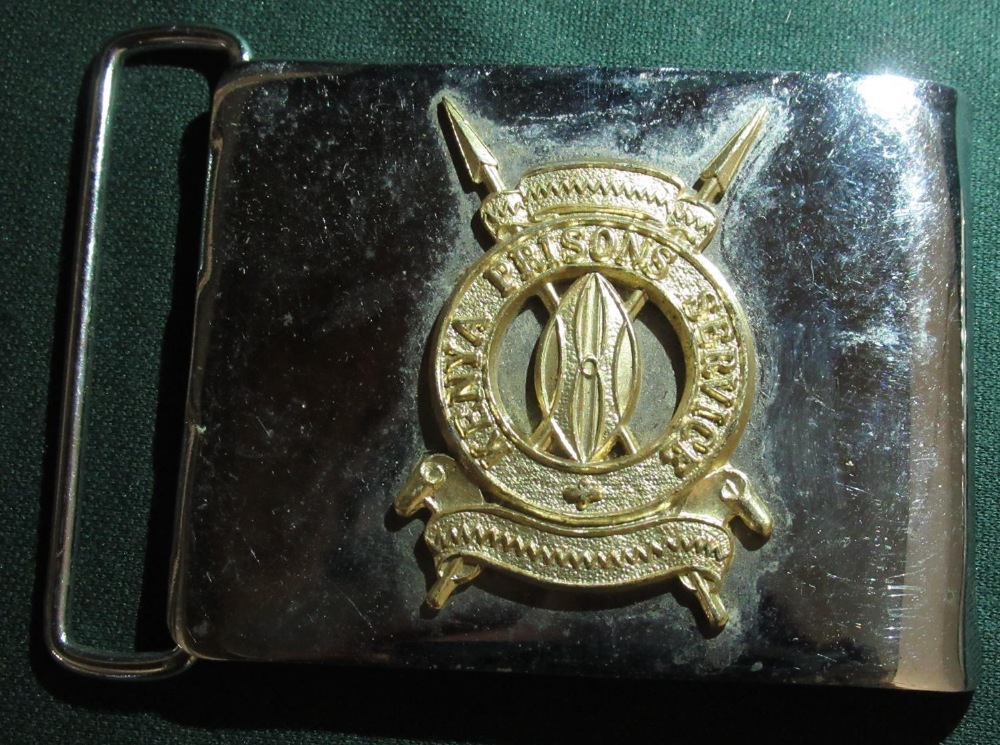 Metal belt buckle with a bucking bronco and a belt buckle with the badge of the Kenyan Prisons - Image 3 of 3