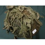 Post WWII helmet with camouflaged netting and webbing