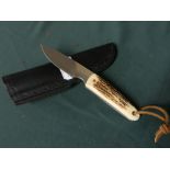 3 inch bladed sheath knife with two piece Sambar horn grip and leather belt sheath