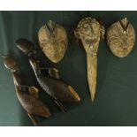 Tribal ceremonial bone dagger with moulded clay figure of a head, inset with shells and hair (