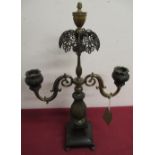 Regency gilt bronze two branch candelabra with open work cresting and urn finial on tapering base