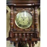 Late 20th C German wall clock in carved oak case with turned finials and gallery, single glazed door