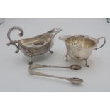 Pair of Victorian silver hallmarked sugar tongs, London 1881, an Edw. VII cream jug, Birmingham 1904