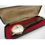 Accurist gold hand wound wristwatch with date two piece case on leather strap, movement stamped