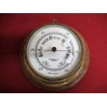 John Barker & Co Ltd Kensington brass cased bulk head aneroid barometer, on golden oak backboard