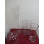 A glass vase in the form of a stemmed wine glass, two plain glass vases and two glass cheese