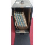 Rondo record cabinet containing a quantity of 78 RPM records and a black Hitachi case containing