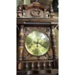 Late 20th C wall clock, in carved oak case with turned finials and gallery, single glazed door