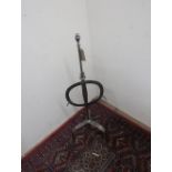 Late 18th C polished iron lark spit with turned finial on three outplayed supports with pad feet