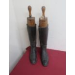 Pair of black leather riding boots complete with brass bound Peale & Co trees and two pairs of