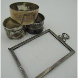 Geo.V and later hallmarked silver - three napkin rings and a rectangular frame, Birmingham,